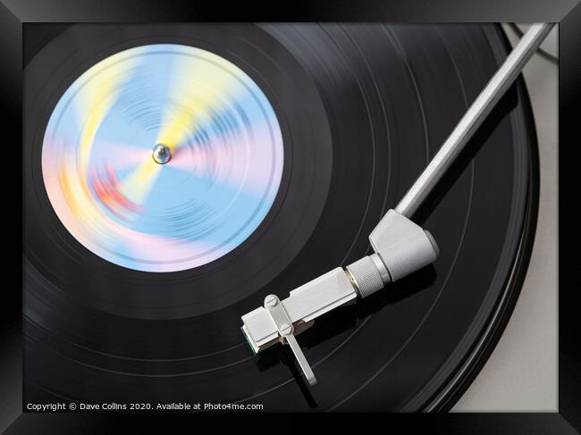 Vinyl Record Playing on a Record Player Framed Print by Dave Collins