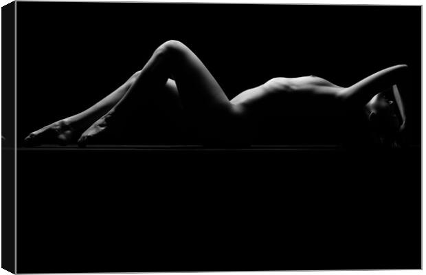 a woman nude and naked in fine art photography bodyscape laying on black studio background Canvas Print by Alessandro Della Torre