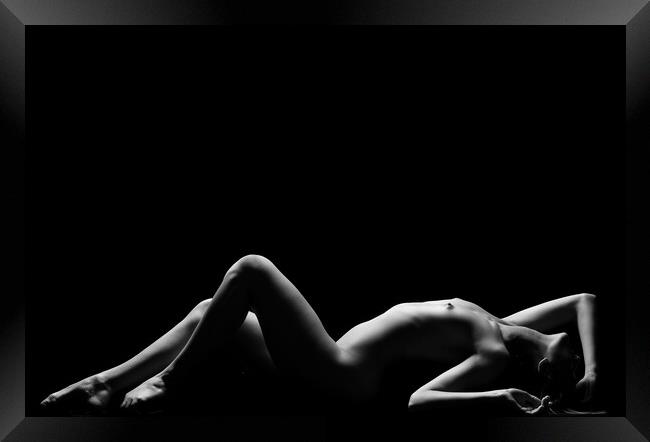 a woman nude and naked in fine art photography bodyscape laying on black studio background Framed Print by Alessandro Della Torre
