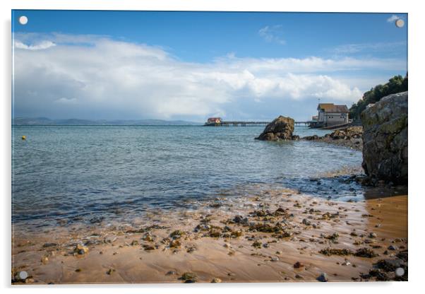 A rocky beach next to a body of water Acrylic by Bryn Morgan