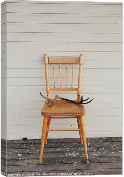 Old vintage wooden chair, with deer antlers Canvas Print by Joaquin Corbalan