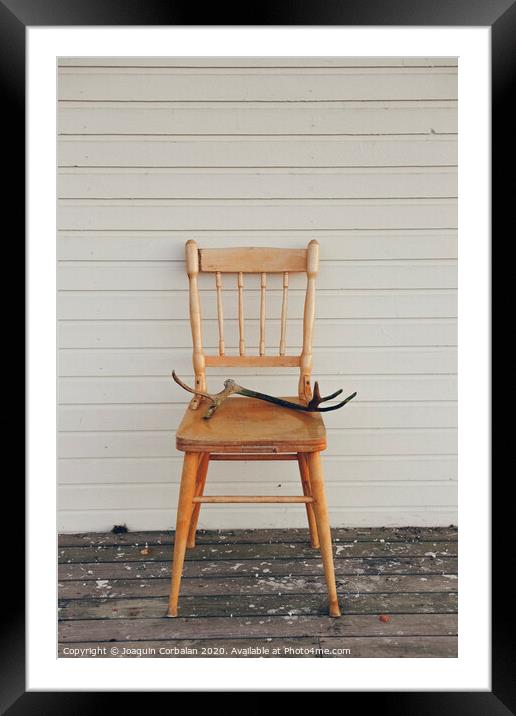 Old vintage wooden chair, with deer antlers Framed Mounted Print by Joaquin Corbalan