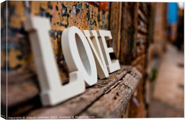 Wooden letters forming the word love Canvas Print by Joaquin Corbalan