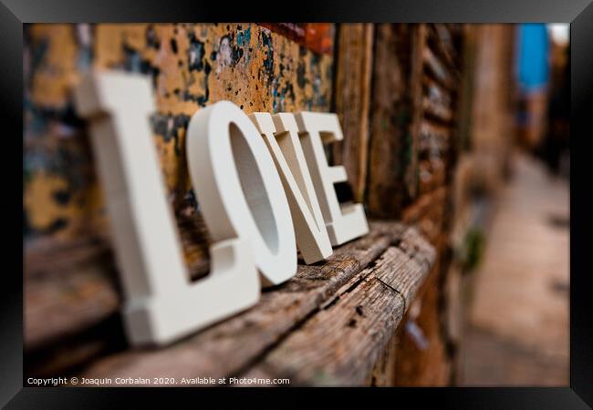 Wooden letters forming the word love Framed Print by Joaquin Corbalan