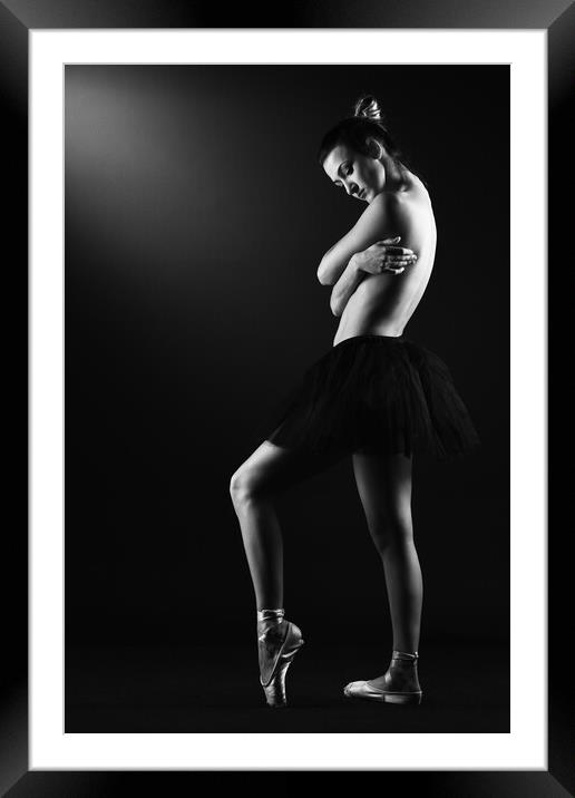 A classic ballerina ballet dancer woman in a classical tutu dress posing on black Framed Mounted Print by Alessandro Della Torre
