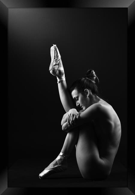 A classic ballerina ballet dancer woman in a classical tutu dress posing on black Framed Print by Alessandro Della Torre