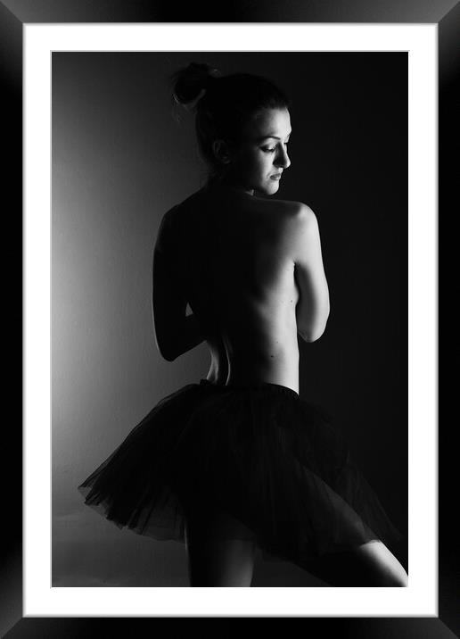 A classic ballerina ballet dancer woman in a classical tutu dress posing on black Framed Mounted Print by Alessandro Della Torre