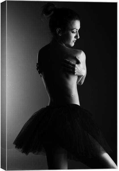 A classic ballerina ballet dancer woman in a classical tutu dress posing on black Canvas Print by Alessandro Della Torre