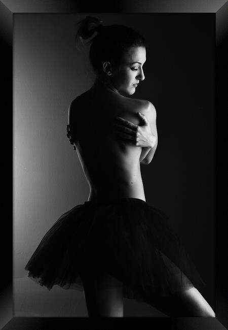 A classic ballerina ballet dancer woman in a classical tutu dress posing on black Framed Print by Alessandro Della Torre