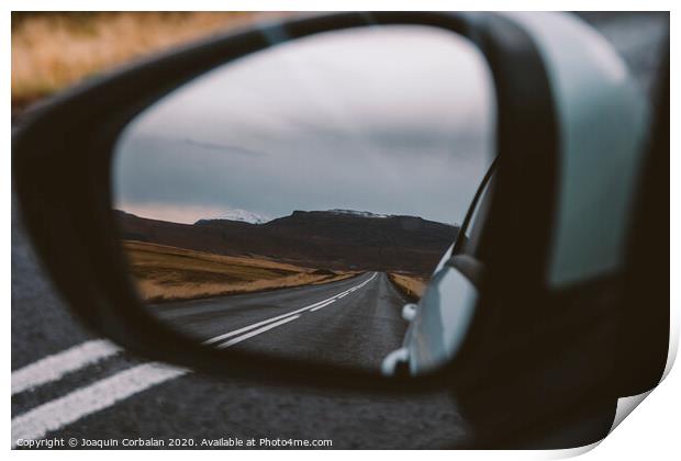 Scene of adventure travel in the mountains driving a car on the road with clouds and snow. Print by Joaquin Corbalan