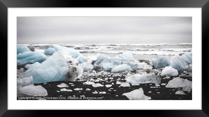 Giant ice blocks detached from icebergs on the coast of an Icelandic beach. Framed Mounted Print by Joaquin Corbalan