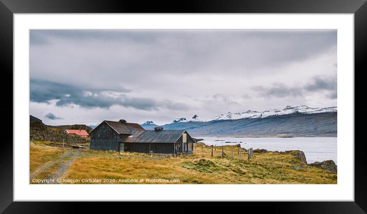 Village with farms in a rural area of the mountains of Iceland, with snowy mountains in the background. Framed Mounted Print by Joaquin Corbalan