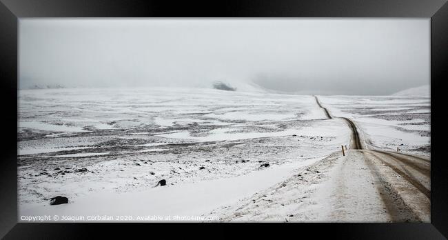 Road covered in snow one winter stormy day, very dangerous to drive due to adverse weather. Framed Print by Joaquin Corbalan