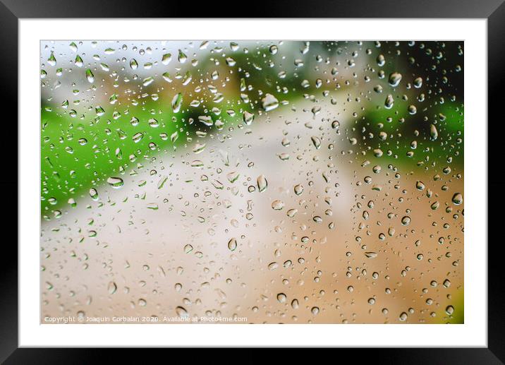 Drops of rain on an autumn day on a glass. Framed Mounted Print by Joaquin Corbalan