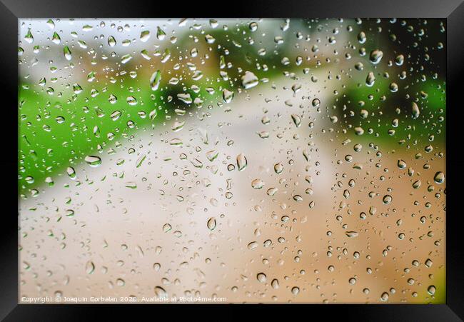 Drops of rain on an autumn day on a glass. Framed Print by Joaquin Corbalan