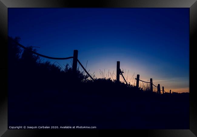 Cold sunset with silhouette of beach dunes Framed Print by Joaquin Corbalan