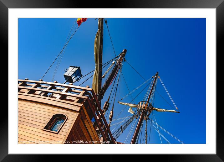 Stern of old galley docked in port to navigate the ocean in the discovery of America. Framed Mounted Print by Joaquin Corbalan