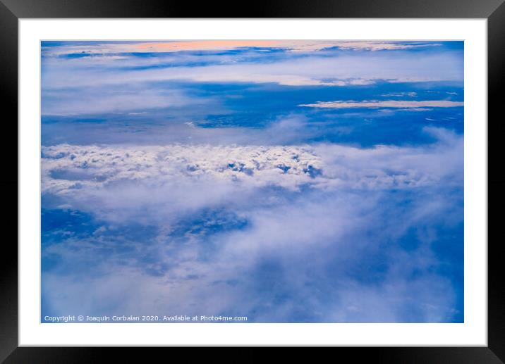 Sea of blue and white clouds seen from above. Framed Mounted Print by Joaquin Corbalan