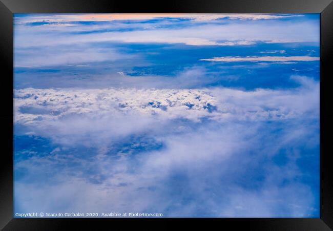 Sea of blue and white clouds seen from above. Framed Print by Joaquin Corbalan
