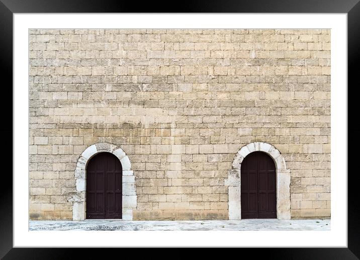 High stone walls with two symmetrical doors, medieval stone background. Framed Mounted Print by Joaquin Corbalan