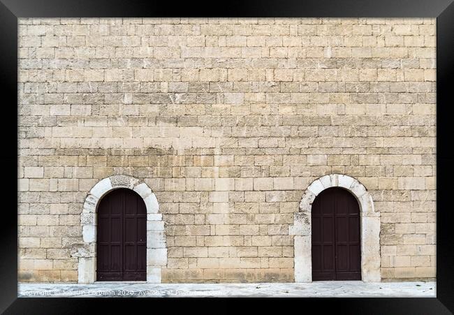 High stone walls with two symmetrical doors, medieval stone background. Framed Print by Joaquin Corbalan