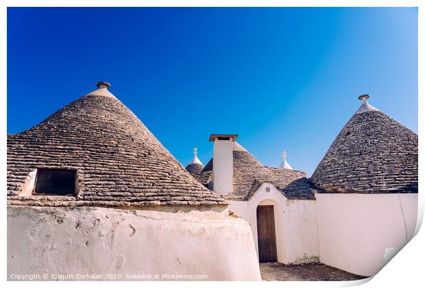 Stone tiles cover the roofs of the trulli in Alberobello, an Italian city to visit on a trip to Italy. Print by Joaquin Corbalan