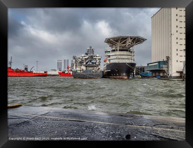 Supply ships for oil and wind power in Esbjerg flooded harbor, Denmark  Framed Print by Frank Bach