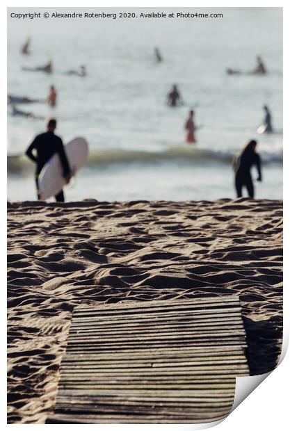 Wooden boards on beach leading to surfers on water Print by Alexandre Rotenberg