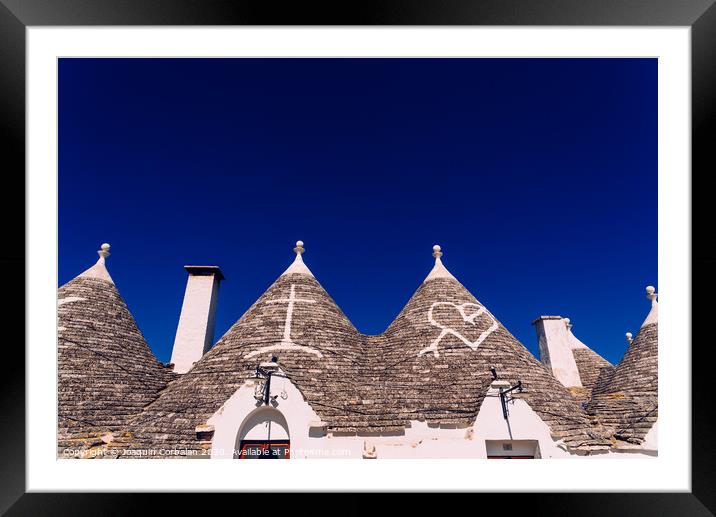 Roofs with symbols in the trulli, in the famous Italian city of Alberobello. Framed Mounted Print by Joaquin Corbalan
