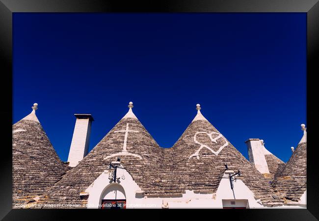 Roofs with symbols in the trulli, in the famous Italian city of Alberobello. Framed Print by Joaquin Corbalan