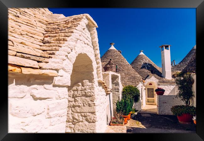 Beautiful single-storey houses of rounded construction called trulli, typical of the area of Alberobello in Italy. Framed Print by Joaquin Corbalan