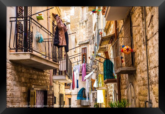 Colorful and old alleys of the touristic Italian city of Bari. Framed Print by Joaquin Corbalan