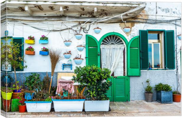 Facades of old Italian Mediterranean houses in Bari painted in colors. Canvas Print by Joaquin Corbalan