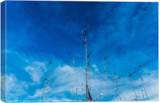Television antennas on the roof of an old building with dramatic sky. Canvas Print by Joaquin Corbalan