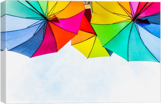 Colorful umbrellas to use as a background in bright and cheerful ideas. Canvas Print by Joaquin Corbalan