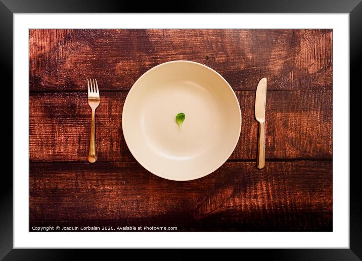 Diet to lose weight, image of plate and cutlery with a little scanty vegetable. Framed Mounted Print by Joaquin Corbalan