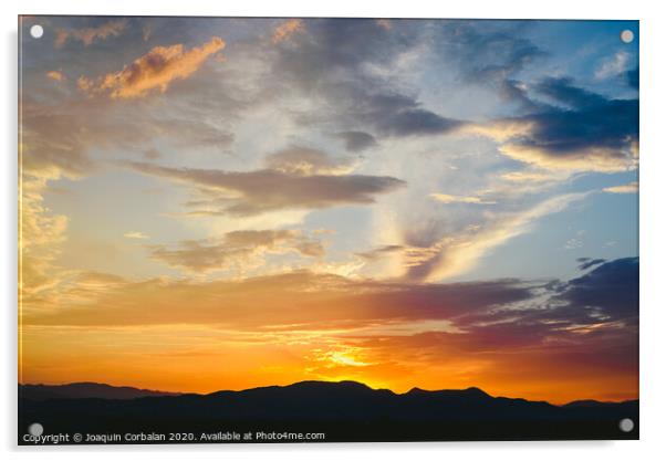 Beautiful sunset with the sun of orange tones behind the mountains and deep blue sky Acrylic by Joaquin Corbalan