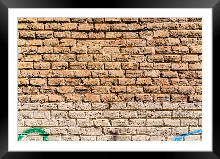 Texture of a brick wall painted in orange tones, ideal for background with space for free text. Framed Mounted Print by Joaquin Corbalan