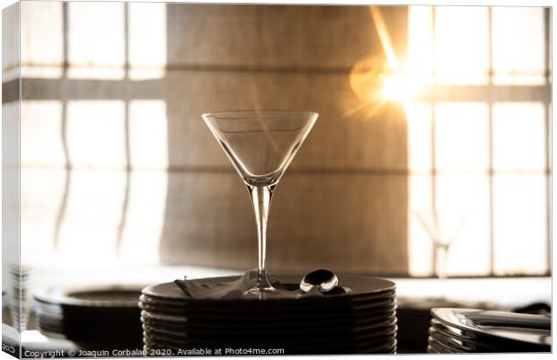 Empty glass cup with sun flares background in a restaurant. Canvas Print by Joaquin Corbalan