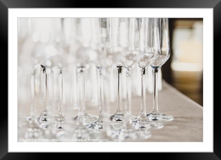 Group of empty and transparent champagne glasses in a restaurant.Group of empty and transparent champagne glasses in a restaurant. Framed Mounted Print by Joaquin Corbalan