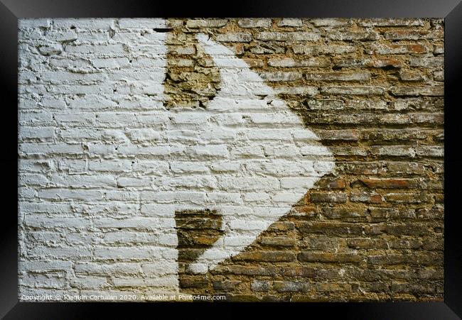 Brick wall with big white arrow indicating direction, background with copy space. Framed Print by Joaquin Corbalan