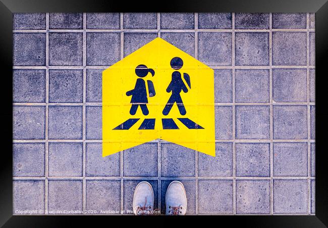 Foot standing on a street a safe way mark for children on the way to school. Framed Print by Joaquin Corbalan