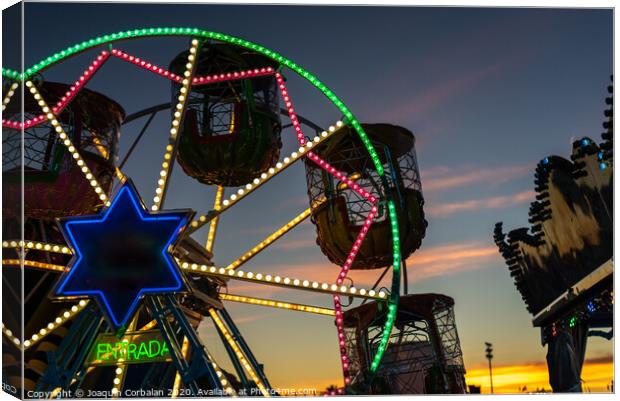 Amusement park at dusk with ferris wheel in the background. Canvas Print by Joaquin Corbalan