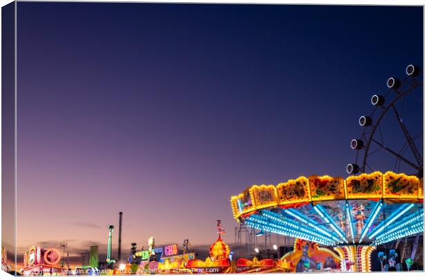 Amusement park at dusk with ferris wheel in the background. Canvas Print by Joaquin Corbalan