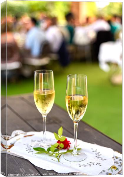 Pair of champagne glasses on a tray to celebrate the love of a couple. Canvas Print by Joaquin Corbalan
