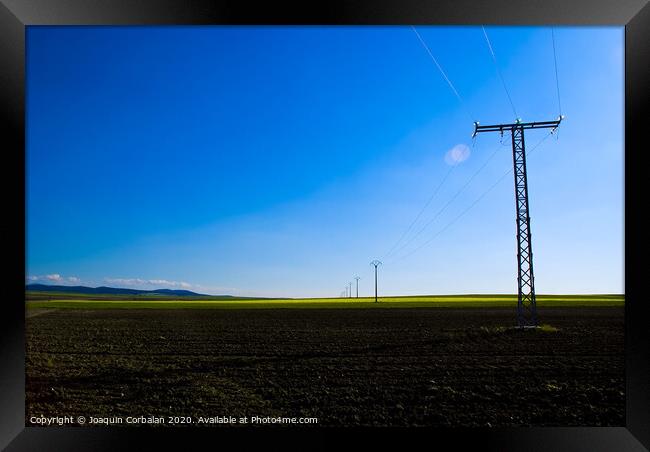 View of a colorful farming field with electricity towers Framed Print by Joaquin Corbalan