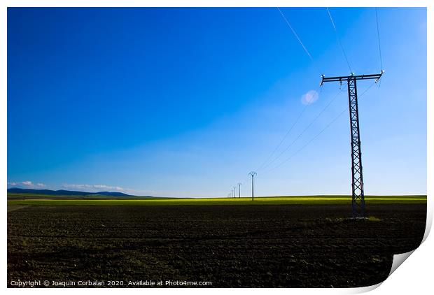 View of a colorful farming field with electricity towers Print by Joaquin Corbalan