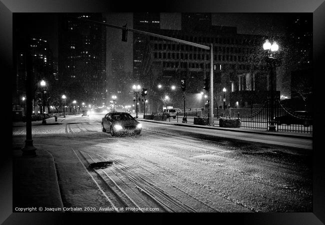 Urban scenes of snowy city at night Framed Print by Joaquin Corbalan