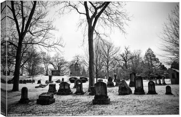 black and white snowy graveyard with aged tombstones Canvas Print by Joaquin Corbalan