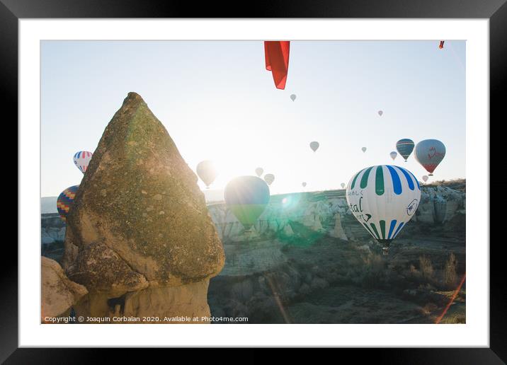 Colorful balloons flying over mountains and with blue sky in cappadocia. Framed Mounted Print by Joaquin Corbalan